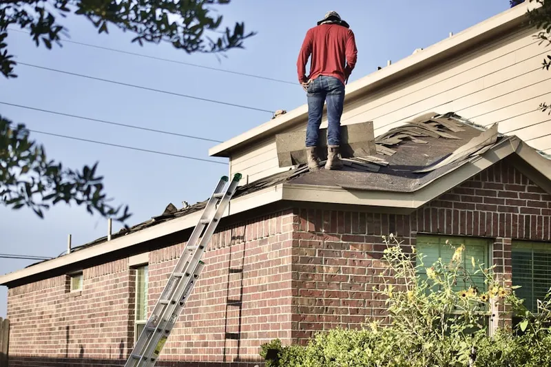 Professional roofer working on a residential roof in West Charleston